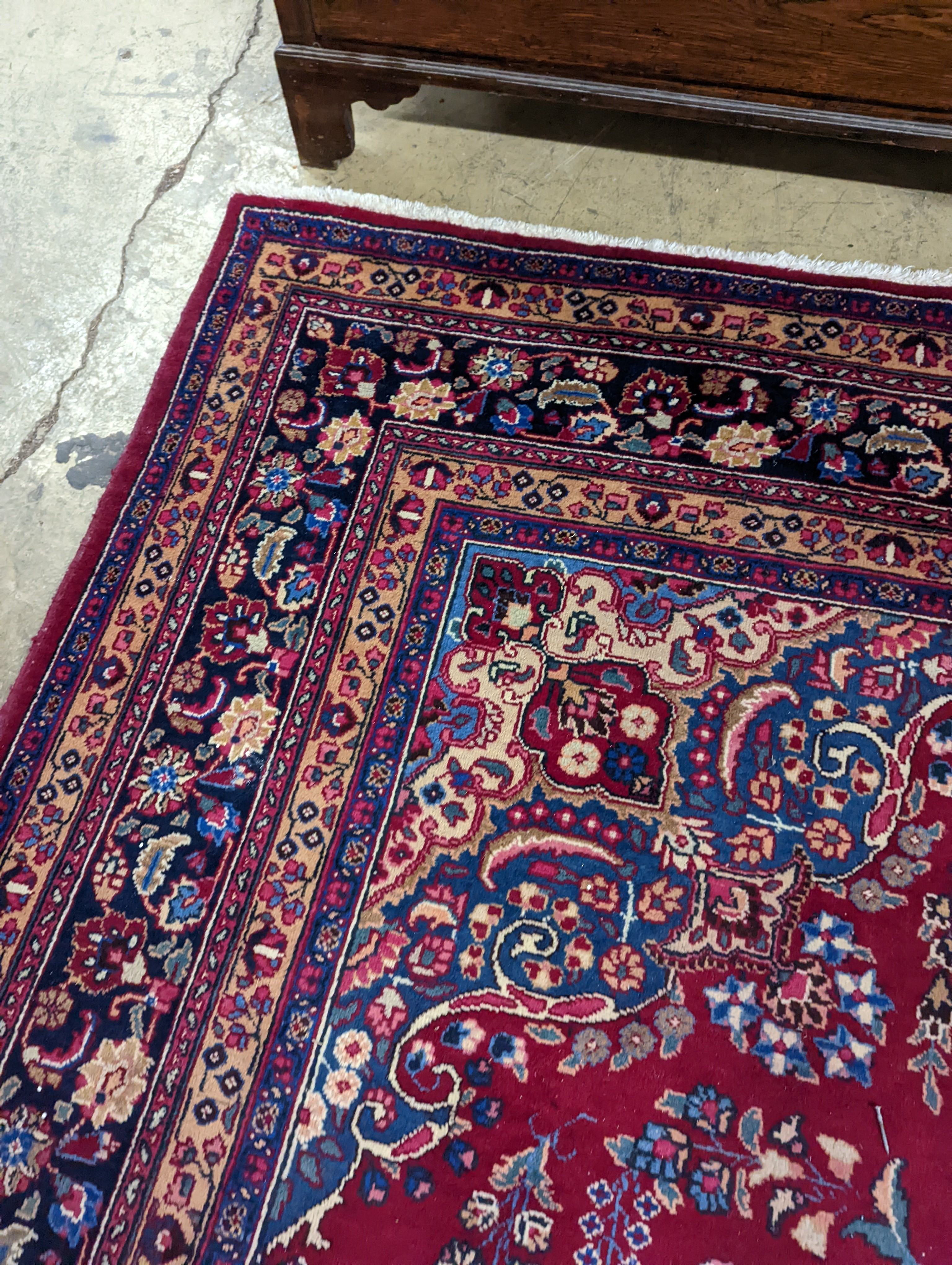 A Tabriz burgundy ground carpet, 350 x 250cm